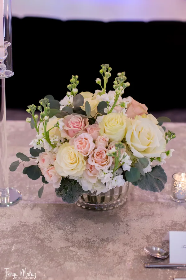 Blush garden roses and stock in a low silver bowl